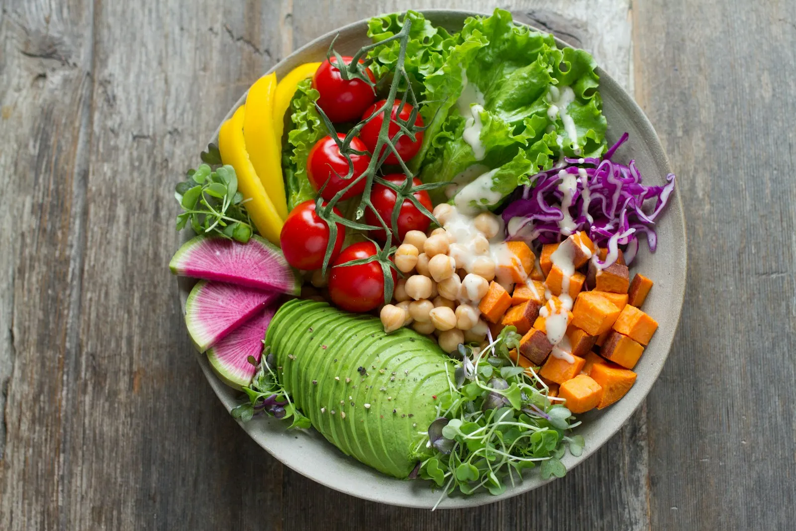 A bowl of salad with avocado, chickpeas, sweet potato and tomatoes being scanned
